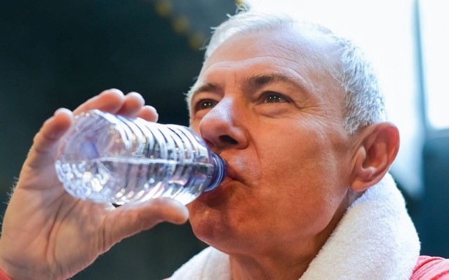A man drinking from a water bottle