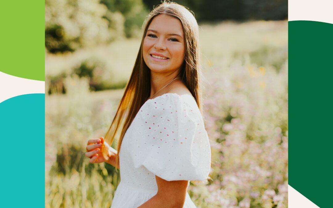 Lily, volunteer with Help At Your Door, smiling in a field